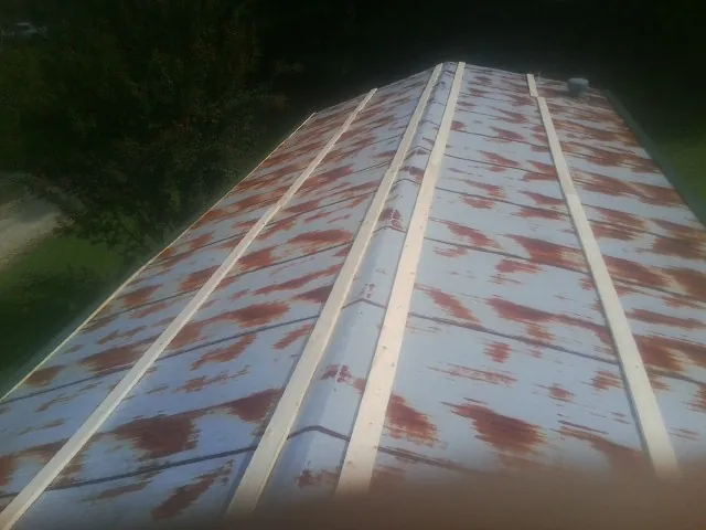 Rusted metal roof panels with new wood purlins before replacement — Storm Damage Roof Repair in Florham Park by Roofing Brothers
