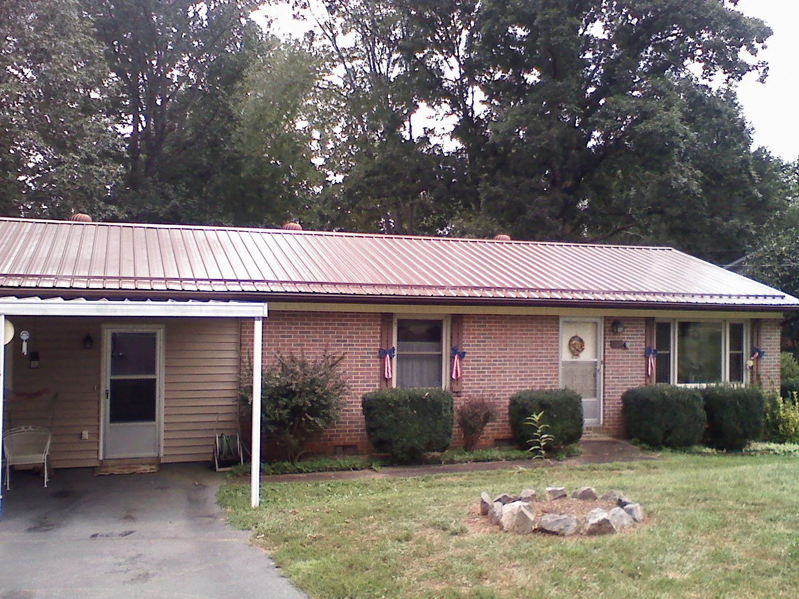 Bronze metal roof and carport on a brick ranch home — Roof Repair work by our crew in Florham Park