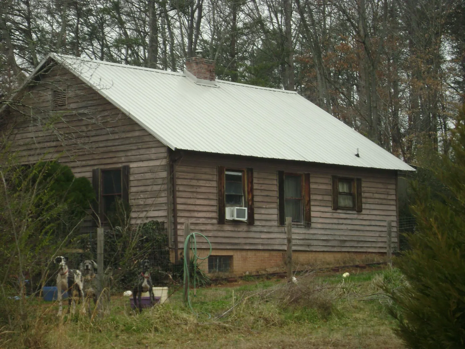 White metal roof on an old wood sided farmhouse, from a Metal Roof Installation job in Florham Park